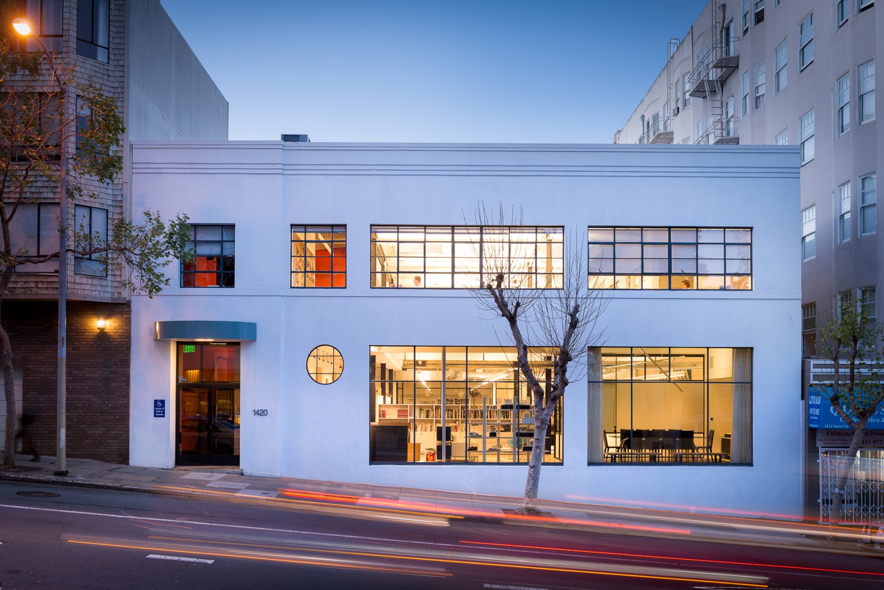Renovated two-story office building at dusk