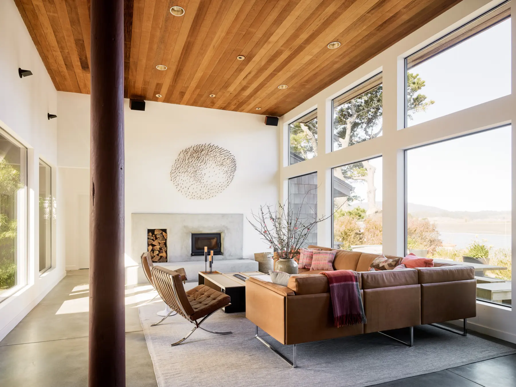 Stinson beach house living room with wood ceilings, concrete floors, and modern furniture