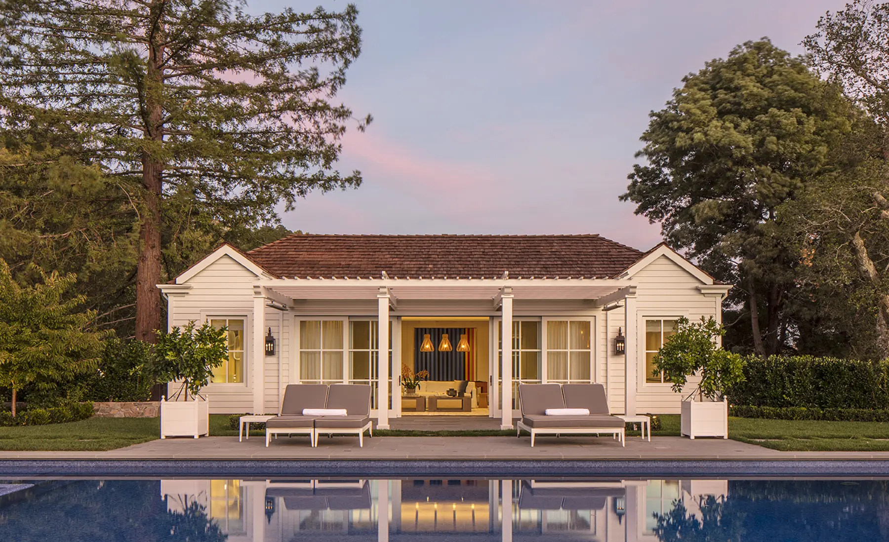 Pool house in kentfield reflecting in swimming pool at sunset