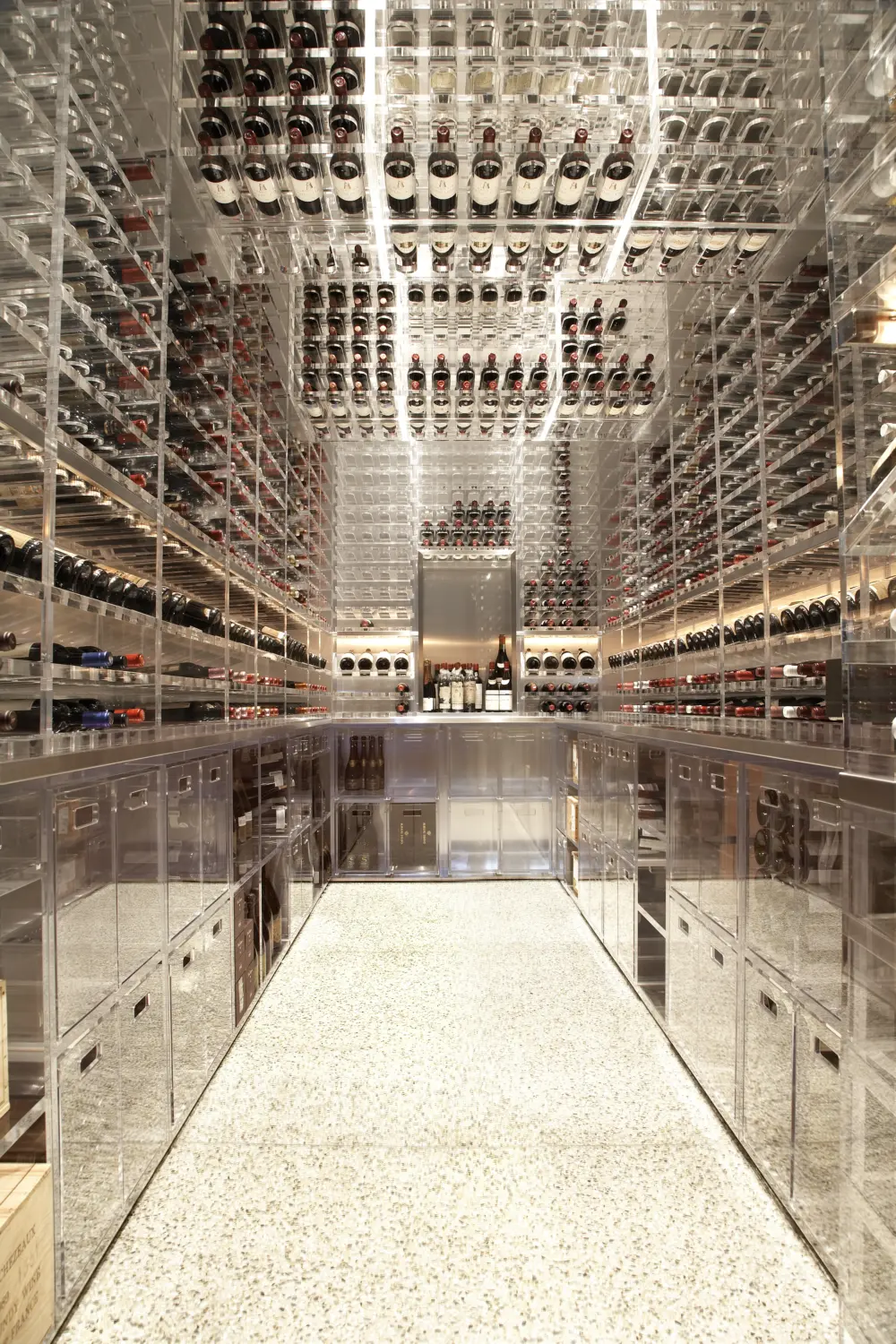 Large floor to ceiling wine cellar with lucite shelving