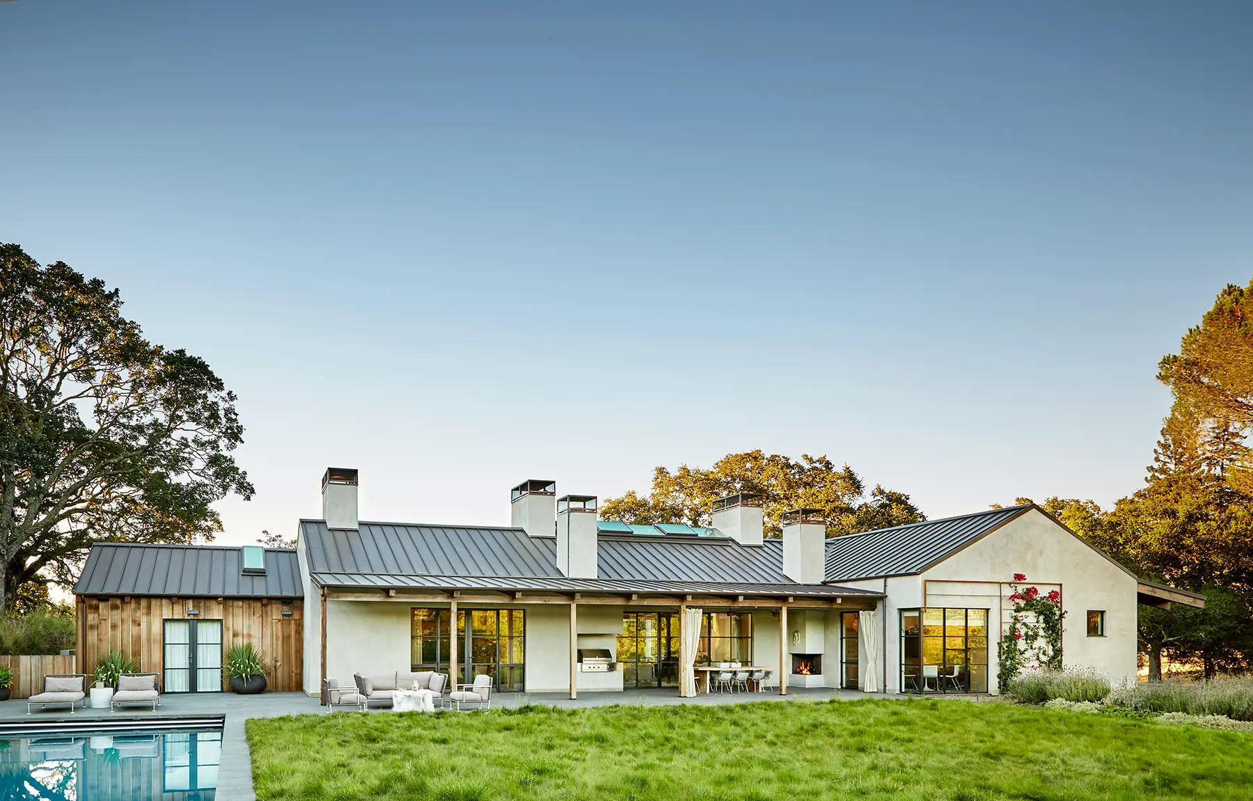 Country courtyard home with rustic wood finishes and stucco exterior