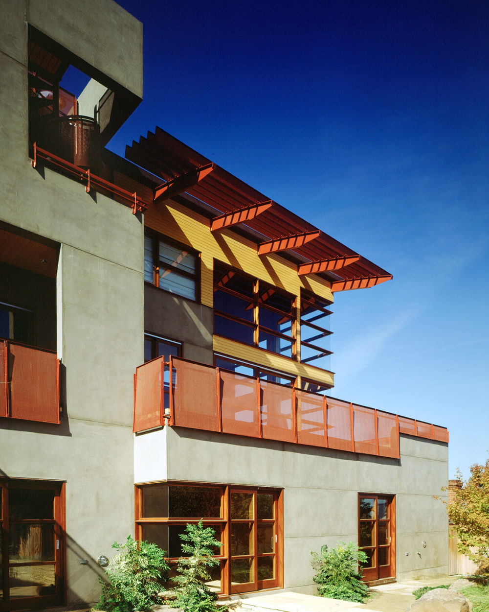Rear exterior of san francisco home with concrete facade, and features resembling the golden gate bridge