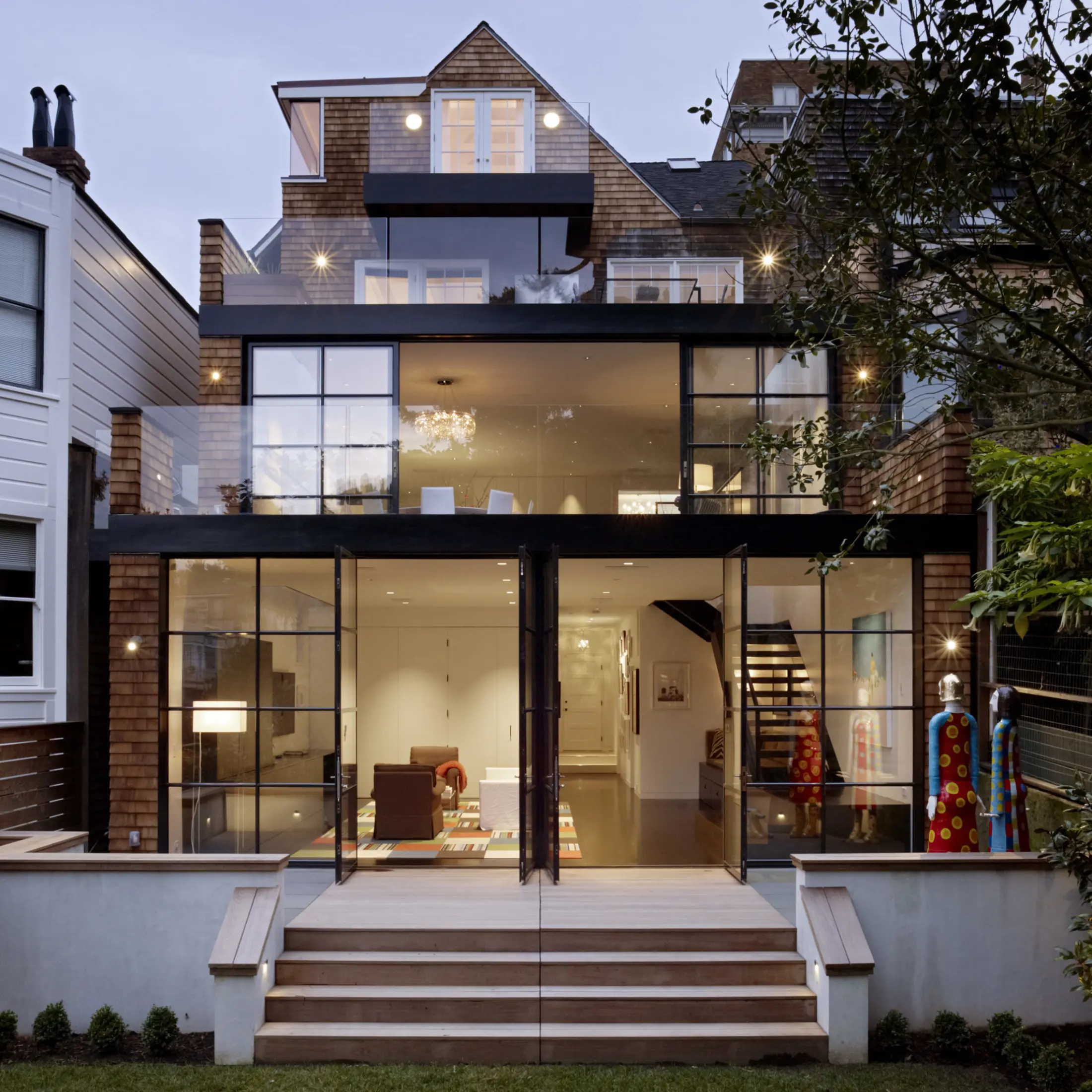 Traditional home with modern glass back facade