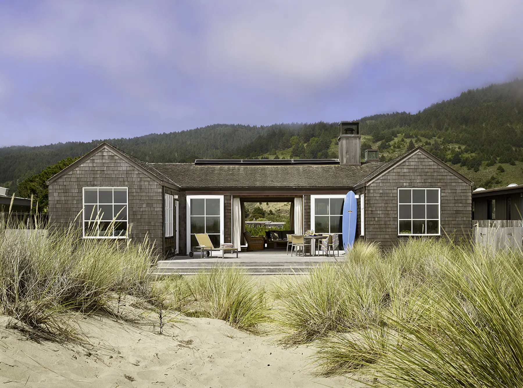 California shingled symmetrical beach house that opens up to grassy dunes