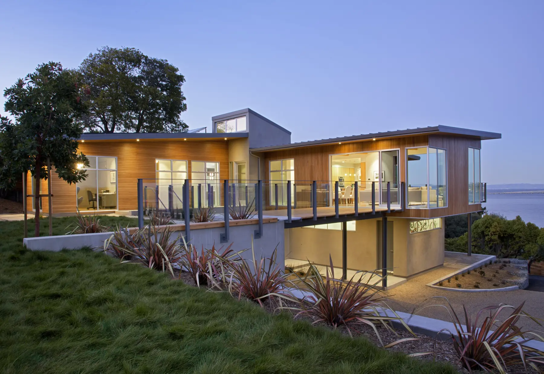 Modern home on coast with glass bridge that connect yard to house